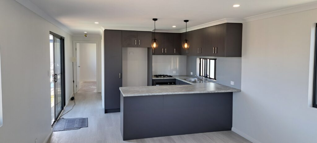 granny flat kitchen with granite table black paint finish